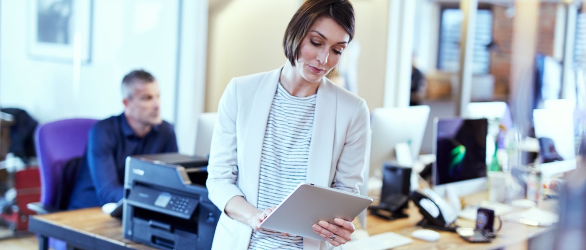 A lady printing a document from a tablet device in a small office environment