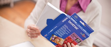 A woman removing a ream of paper from packaging