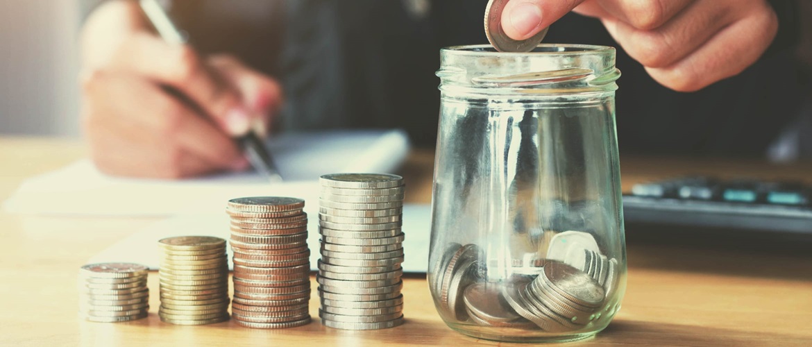 hand placing coins into a jar, to highlight the concept of cost control