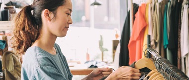 A young woman business owner works in her vintage clothing shop