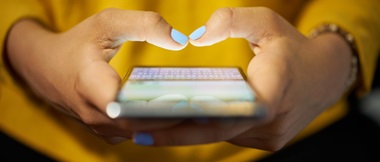 Small medium business employee uses smart phone to complete work task