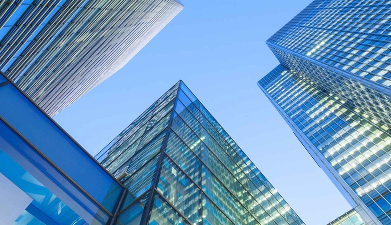 Skyscrapers from a ground perspective with blue sky in the background