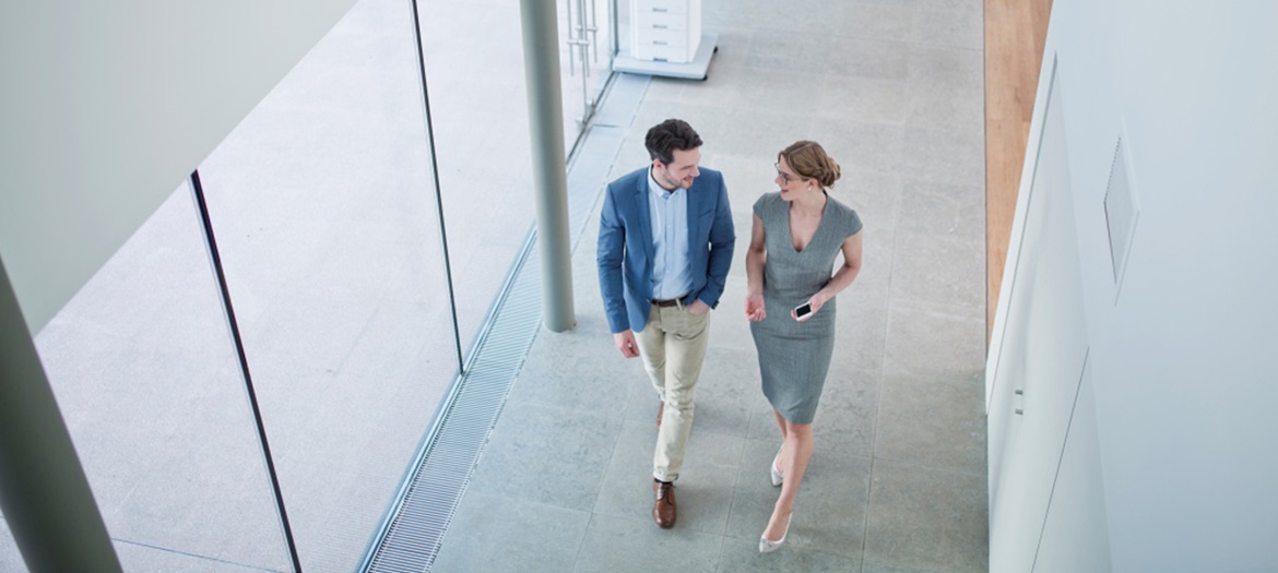 Man and woman chatting in corridor