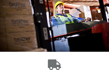 Man with hi-vis jacket and hard hat using forklift truck